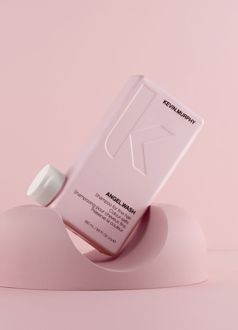 Kevin Murphy Angel Wash shampoo bottle on a pink background