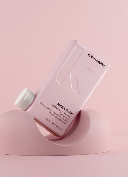 Kevin Murphy Angel Wash shampoo bottle on a pink background